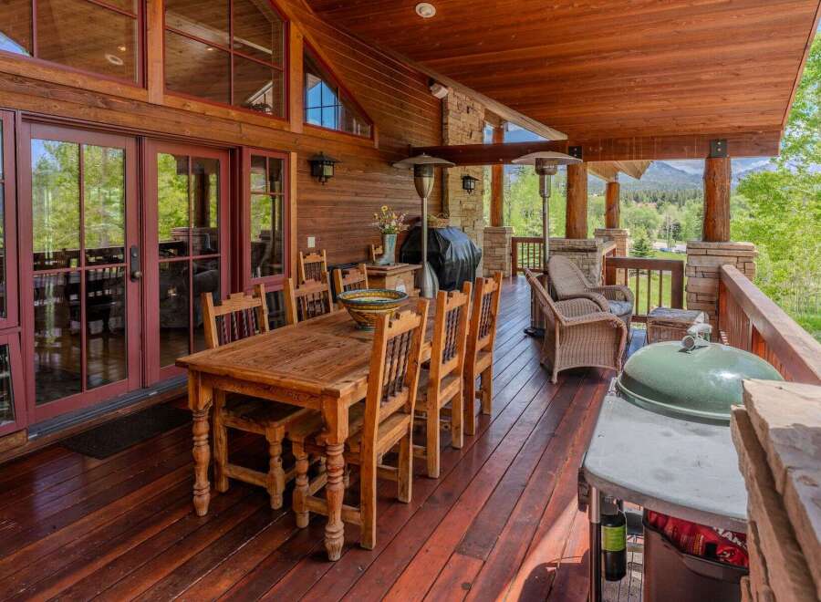 Experience outdoor living at its finest on this expansive covered deck, perfect for entertaining or relaxing amidst stunning mountain views.