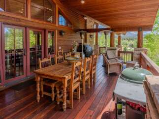 Experience outdoor living at its finest on this expansive covered deck, perfect for entertaining or relaxing amidst stunning mountain views.