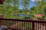 Enjoy serene mountain living with this stunning property featuring a private pond and lush greenery.
