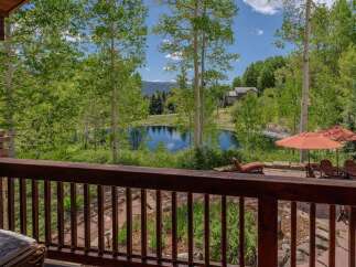 Enjoy serene mountain living with this stunning property featuring a private pond and lush greenery.