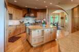 Experience luxury in this stunning kitchen featuring custom light wood cabinetry and granite countertops.