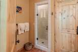 Step into a spa-like bathroom featuring a charming glass-enclosed shower with white tiled walls and a convenient towel rack.