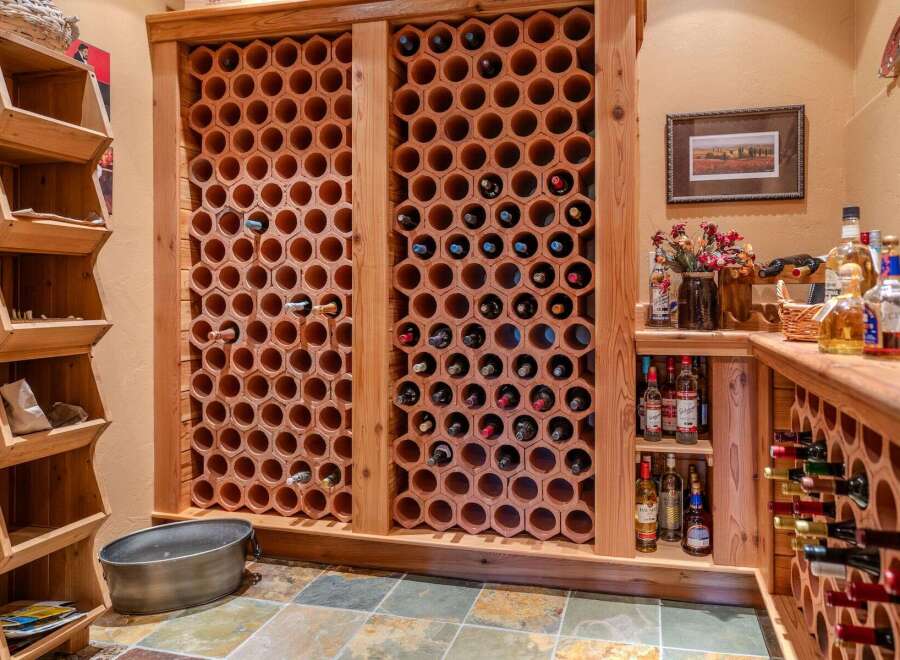 Discover the ultimate wine enthusiast's dream with this custom-built wine cellar, featuring hexagonal terracotta racks for optimal bottle storage and preservation.