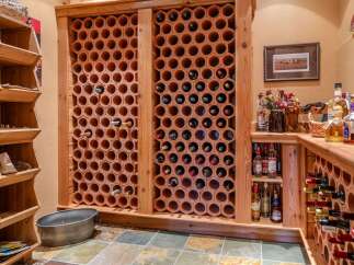 Discover the ultimate wine enthusiast's dream with this custom-built wine cellar, featuring hexagonal terracotta racks for optimal bottle storage and preservation.