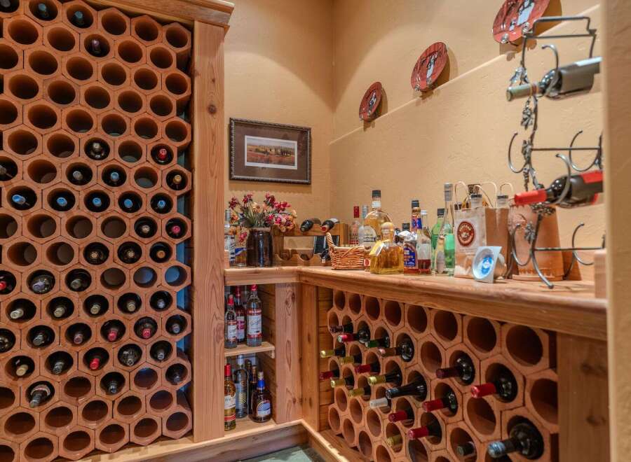 Discover this charming wine cellar featuring hexagonal terracotta racks, perfect for storing your favorite vintages.