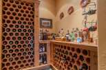 Discover this charming wine cellar featuring hexagonal terracotta racks, perfect for storing your favorite vintages.