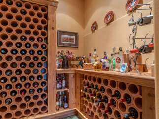 Discover this charming wine cellar featuring hexagonal terracotta racks, perfect for storing your favorite vintages.