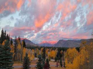 Experience the magic of autumn in this stunning mountain landscape, perfect for a serene getaway.