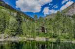 Nestled amidst a serene forest and overlooking a tranquil lake, this stunning property offers a unique blend of natural beauty and rustic charm.