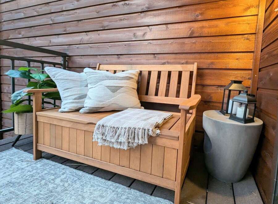 Enhance your outdoor living space with this charming wooden bench, perfect for a patio or deck.
