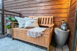 Enhance your outdoor living space with this charming wooden bench, perfect for a patio or deck.