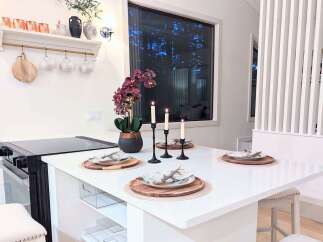 Experience modern living in this stylish kitchen island, perfect for intimate dining or casual entertaining.