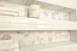 Experience luxury in this bathroom featuring elegant marble hexagon tile accents within built-in niches.