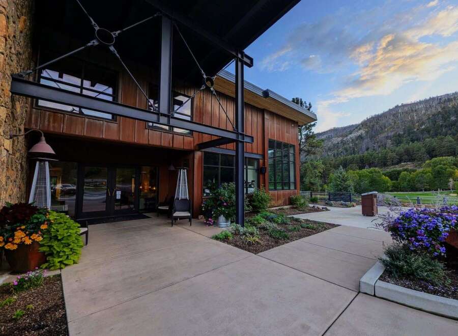 Experience the perfect blend of rustic charm and modern design at this stunning property, featuring a striking stone and wood exterior complemented by expansive windows.