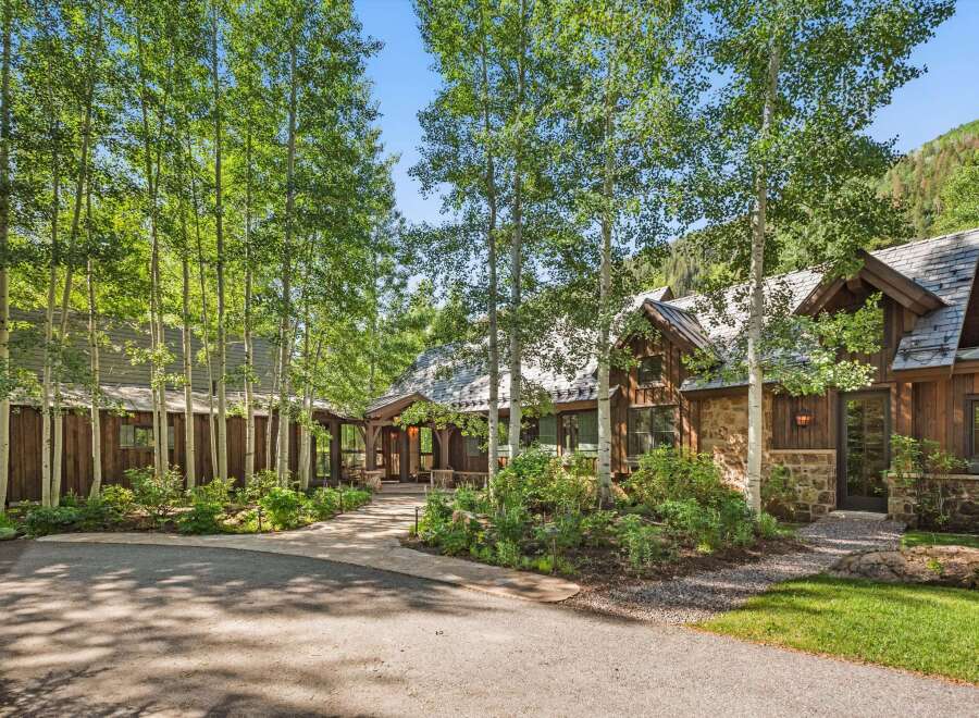 Nestled amidst a grove of aspen trees, this stunning mountain home offers a serene retreat.