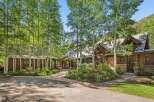 Nestled amidst a grove of aspen trees, this stunning mountain home offers a serene retreat.