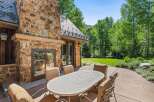 Enjoy al fresco dining on this charming patio, complete with a large stone fireplace perfect for cool evenings.