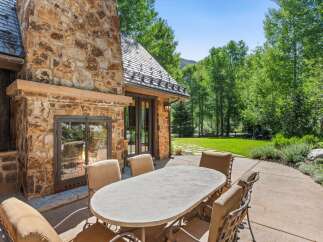 Enjoy al fresco dining on this charming patio, complete with a large stone fireplace perfect for cool evenings.