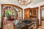 Experience rustic luxury in this stunning mountain home, featuring a gourmet kitchen with a granite island and professional-grade appliances.
