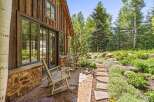 Experience rustic charm with this inviting cabin exterior, featuring natural wood siding and a stone foundation.