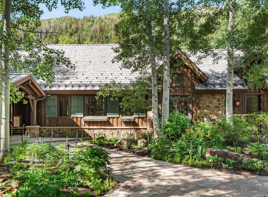 Nestled amidst lush greenery and mature trees, this charming mountain home offers a serene retreat.