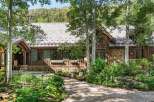 Nestled amidst lush greenery and mature trees, this charming mountain home offers a serene retreat.