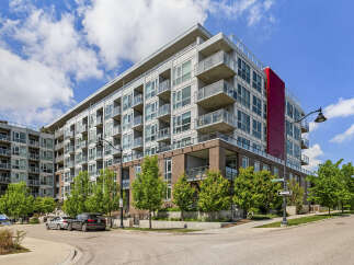 Discover modern urban living in this stunning condo building featuring sleek architecture and private balconies.