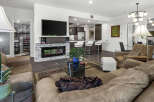 Experience modern living in this stylish condo featuring an open-concept living area with a sleek fireplace and a gourmet kitchen with bar seating.