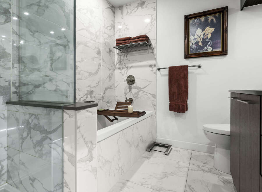 Experience modern luxury in this stunning bathroom, featuring elegant marble tilework throughout.