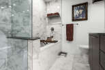 Experience modern luxury in this stunning bathroom, featuring elegant marble tilework throughout.