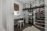 Discover your dream closet with this beautifully organized dressing area, featuring a chic vanity with a lighted mirror and ample storage for all your accessories.
