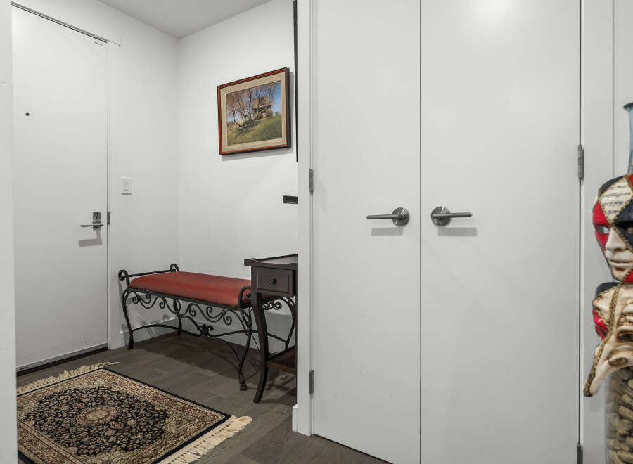 Step into this inviting entryway featuring a charming red bench and a decorative rug, perfect for welcoming guests.