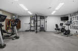 This modern gym features a variety of cardio and strength training equipment, including elliptical machines, stationary bikes, and a functional trainer.