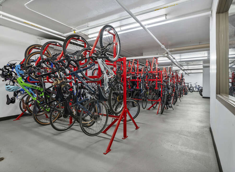 Secure your active lifestyle with this dedicated bike storage facility, featuring a multi-level rack system designed to maximize space and protect your bicycles.
