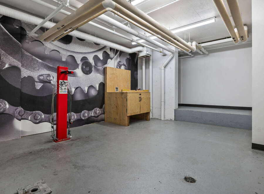 This industrial-chic space features a striking mural of bicycle gears and chains, creating a unique and dynamic atmosphere.