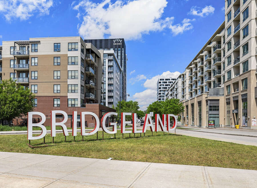Discover modern living in this vibrant urban community, featuring stylish apartment buildings with balconies and large windows.