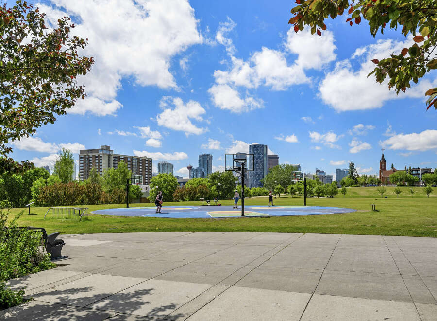 Enjoy an active lifestyle in this vibrant urban park, featuring a colorful basketball court perfect for friendly games.
