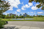 Enjoy an active lifestyle in this vibrant urban park, featuring a colorful basketball court perfect for friendly games.