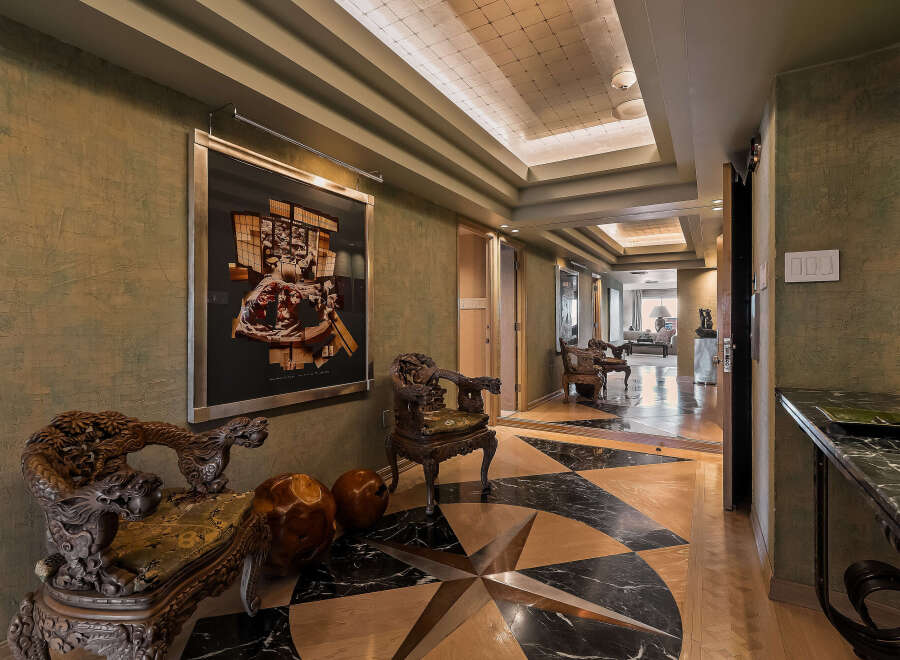 Step into this luxurious entryway featuring a striking compass rose inlay on the floor, crafted from polished wood and marble.