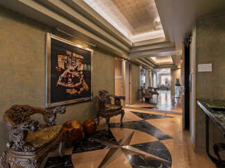Step into this luxurious entryway featuring a striking compass rose inlay on the floor, crafted from polished wood and marble.