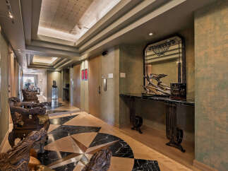 Experience opulent living in this luxurious hallway featuring intricate dragon-carved chairs and a stunning marble console table.