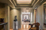 Step into this luxurious hallway featuring a stunning geometric marble and wood inlay floor that guides you towards a beautifully appointed living space.