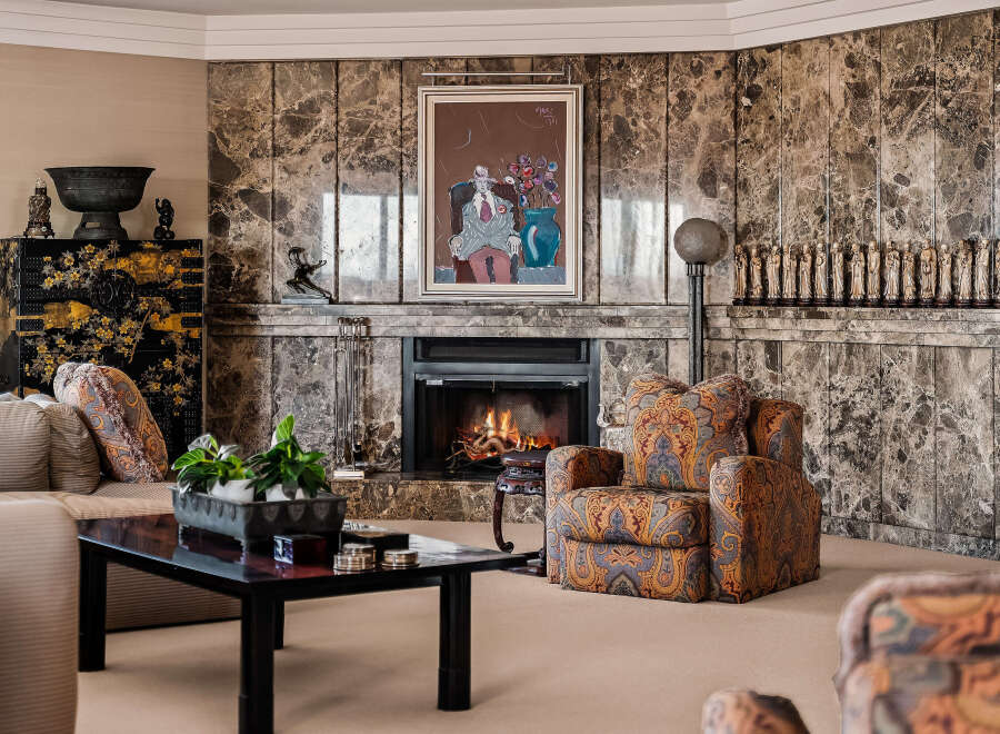 Experience luxury living in this elegant living room, featuring a stunning marble fireplace as the centerpiece.