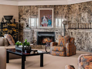 Experience luxury living in this elegant living room, featuring a stunning marble fireplace as the centerpiece.