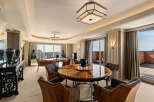 Experience luxurious living in this expansive dining area, featuring two elegant round dining tables perfect for hosting.
