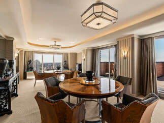 Experience luxurious living in this expansive dining area, featuring two elegant round dining tables perfect for hosting.