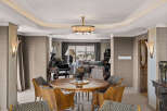 Experience elegant dining in this sophisticated space, featuring a stunning round wood table surrounded by uniquely designed chairs.