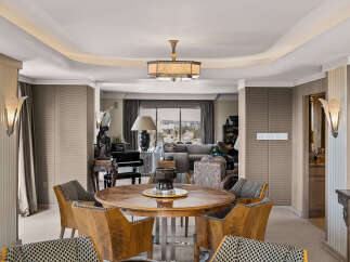 Experience elegant dining in this sophisticated space, featuring a stunning round wood table surrounded by uniquely designed chairs.