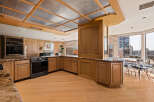 Experience luxury living in this stunning kitchen featuring elegant wood cabinetry and granite countertops.