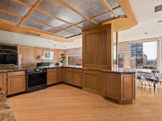 Experience luxury living in this stunning kitchen featuring elegant wood cabinetry and granite countertops.